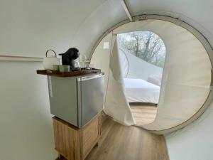 a round mirror in a room with a bed at Fun'ambulle in Féneyrols