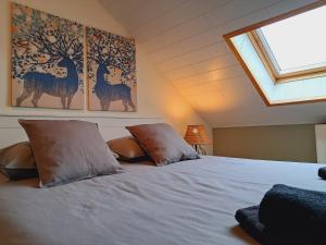 a bedroom with a bed with two pillows on it at Au Pachis - Maison de vacances Houffalize in Houffalize