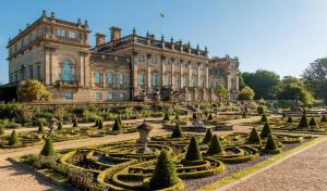 an old building with a garden in front of it at Fountains Executive Apartment - Harrogate Stays in Harrogate