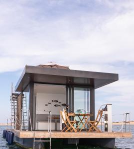 a small house on a boat in the water at Barco Casa Marina Fuzeta in Fuzeta