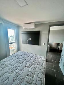 um quarto com uma cama e uma televisão de ecrã plano em Apartamento de Alto Padrão Recém Inaugurado em Campina Grande
