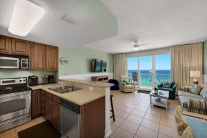 a kitchen and living room with a view of the ocean at Seychelles 1007 in Panama City Beach