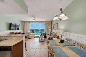 a living room with a couch and a table at Seychelles 1007 in Panama City Beach