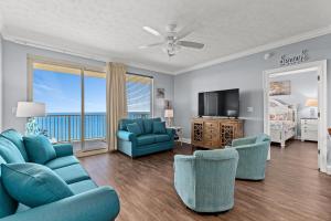 a living room with a couch and chairs and a television at Treasure Island 2109 in Panama City Beach