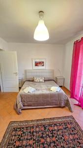 a bedroom with a large bed with pink curtains at B&B Luna Nuova in Sarzana