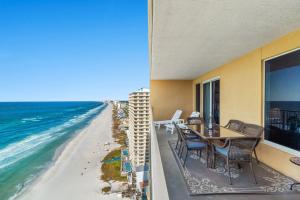 a balcony with a table and chairs and the beach at Treasure Island 2109 in Panama City Beach