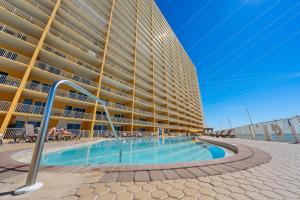 a large building with a swimming pool in front of it at Treasure Island 2109 in Panama City Beach