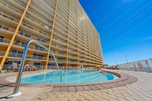 a large building with a swimming pool in front of it at Treasure Island 1808 in Panama City Beach