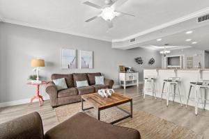 a living room with a couch and a table at Treasure Island 2306 in Panama City Beach