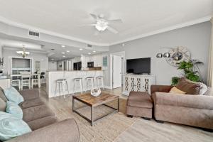 a living room with a couch and a table at Treasure Island 2306 in Panama City Beach