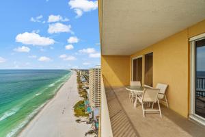 a balcony with a table and chairs and the ocean at Treasure Island 2306 in Panama City Beach