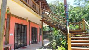 a building with a staircase next to a building at Chalés Yababali in Ubatuba