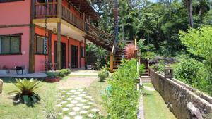 a house with a staircase in front of it at Chalés Yababali in Ubatuba