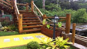 a wooden stairway with a set of stairs in a yard at Chalés Yababali in Ubatuba +111 photos