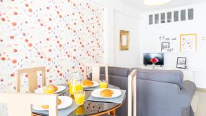 a dining room with a table with food on it at Home Amatista Málaga in Málaga