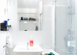 a white bathroom with a sink and a shower at Home Amatista Málaga in Málaga