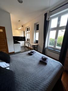 a bedroom with a bed with two towels on it at Magic Sopot Apartments in Sopot