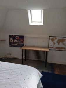 a bedroom with a bed and a window in it at Helocar in Morlaix