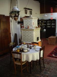 a dining room table with a white table cloth at Cascina nel bosco in Moncucco Torinese