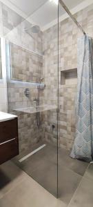 a bathroom with a shower with a glass door at Apartment Denis in Krk