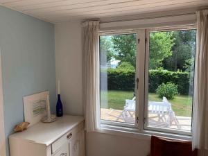 a room with a window with a view of a yard at Traditional Danish Summer House in Hornslet