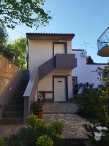 a house with a staircase leading up to it at Apartments D in Premantura