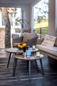 a living room with two tables with fruit on it at Tiny home Rubi in Oaza Mira resort in Drage