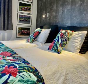 twee bedden met kussens in een slaapkamer bij "Un matin au jardin" in Francorchamps