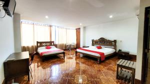 a large room with two beds in a room at Hotel Beijing Caucasia in Caucasia