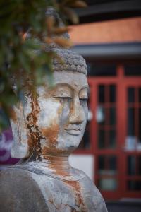 a statue of aitating woman in front of a building at Pagoda Resort & Spa in Perth