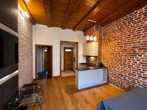 a kitchen with a brick wall and a counter top at Magic Sopot Apartments in Sopot