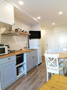 a kitchen with white appliances and a table and chairs at Porto Ville Touring in Porto