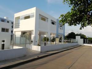 a white building with a fence in front of it at XXXXXX Apartamento amoblado #FESTIVALVALLENATO, MInimo 4 noches in Valledupar