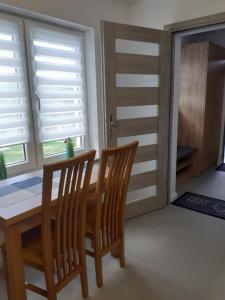a dining room with a table and two chairs at Domek Pod Prehybą -Agroturystyka in Gaboń