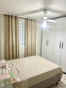 um quarto com uma cama e uma ventoinha de tecto em Apartamento Mobiliado em Limeira em Limeira