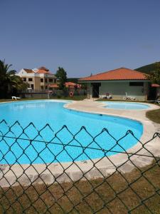 una valla frente a una piscina en camping Pradon, en Arnuero