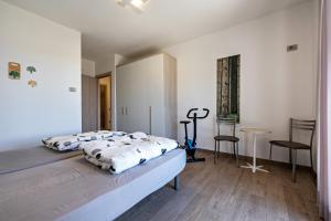a bedroom with a bed and a table and chairs at Agriturismo Bocca Nevese Abete in Tremosine Sul Garda