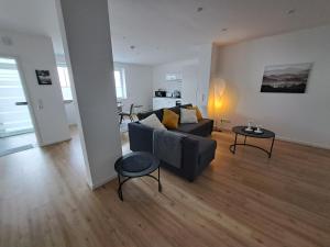 a living room with a couch and two tables at Ferienwohnung Kreuztal in Kreuztal