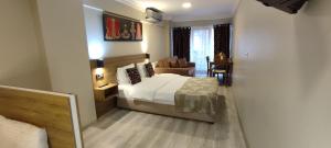 a bedroom with a bed and a living room at Ortaköy Suites Hotel in Istanbul