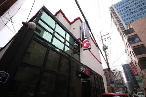 a building with a sign on the side of it at G Mini Hotel Dongdaemun in Seoul