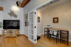 a living room with a television and a table and chairs at Quinn Peaks Retreat House in Bozeman +48 photos