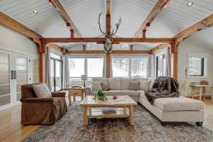 a living room with a couch and a table at Quinn Peaks Retreat House in Bozeman