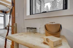 a wooden table in a room with a window at Quinn Peaks Retreat House in Bozeman