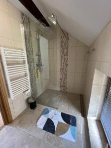 a bathroom with a shower with a rug on the floor at Cottage - The Moulin Treillard - Sleeps3 - Parking in Saint-Hilaire-La-Treille +26 photos