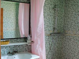 a bathroom with a sink and a shower with a mirror at HOSTAL LA SAVINA in Cervera