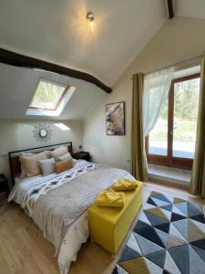 a bedroom with a large bed and a window at Cottage - The Moulin Treillard - Sleeps3 - Parking in Saint-Hilaire-La-Treille