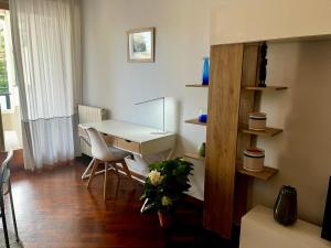 a room with a desk and a table and chairs at INTERO APPARTAMENTO EUR Torrino NUOVO LiFeHome in Rome