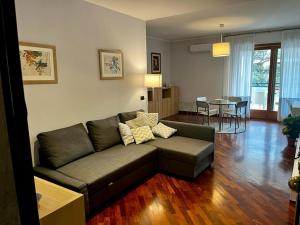 a living room with a couch and a table at INTERO APPARTAMENTO EUR Torrino NUOVO LiFeHome in Rome