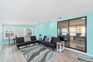 a living room with a couch and a table at Beach House - Moasis by Panhandle Getaways in Panama City Beach