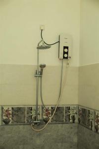 a shower in the corner of a bathroom at Panora Garden in Mirissa